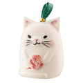 A white ceramic cat ornament with a red ball of yarn in its paw, designed for Christmas tree decoration.