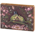 Decorative box sign with two frogs in love and flowers on a dark background
