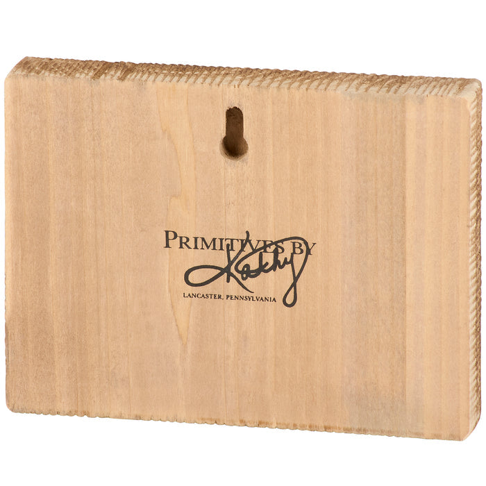Back of a wooden box sign with 'Primitives by Kathy' logo on a white background