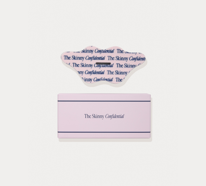 A pink rectangular box with a clear plastic lid, both printed with the text 'The Skinny Confidential', shown on a light gray background.