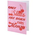 Pink card with red text and cherries on a white background