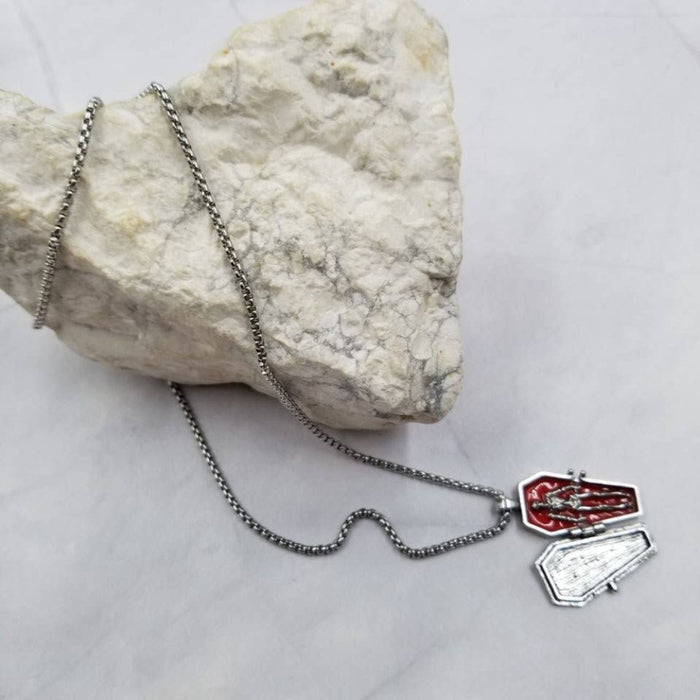 Necklace with coffin pendant on a rock
