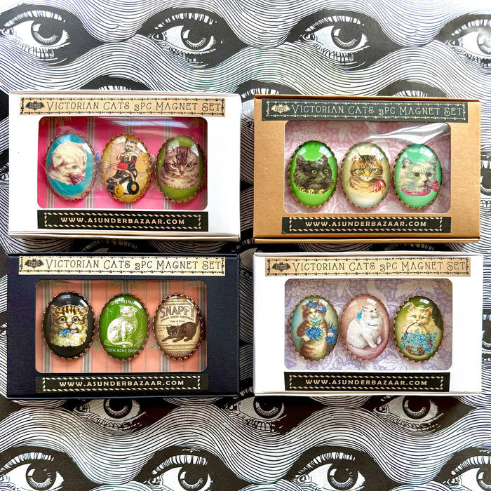 Four boxes of Victorian Cats & Co. magnet sets with decorative packaging.